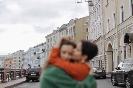queer couple hugging in European city