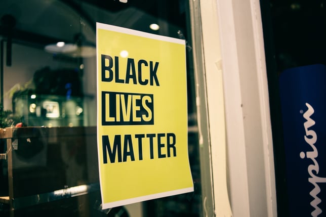 yellow black lives matter sign on business window
