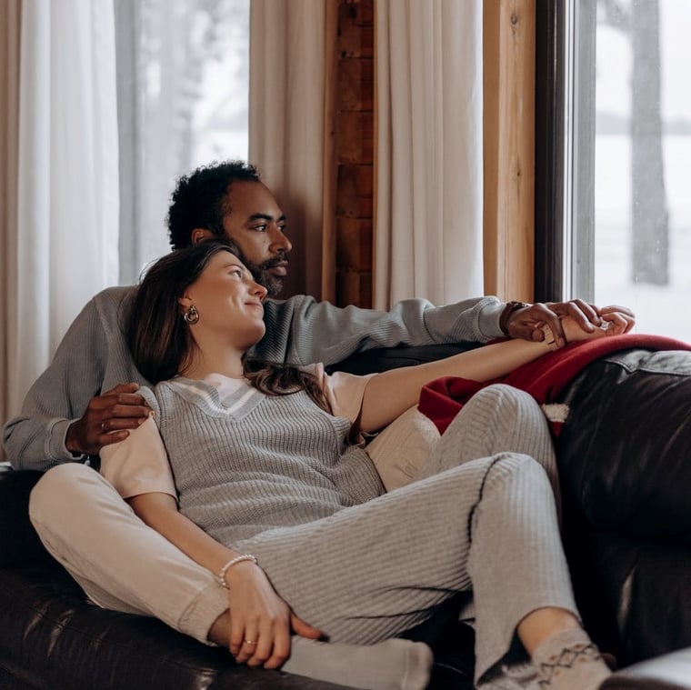 Happy couple relaxing on couch.